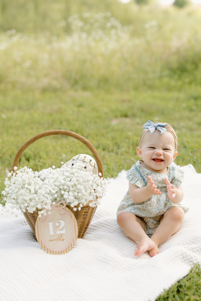 baby clapping while sitting on a blanket during Indianapolis Milestone Photography session