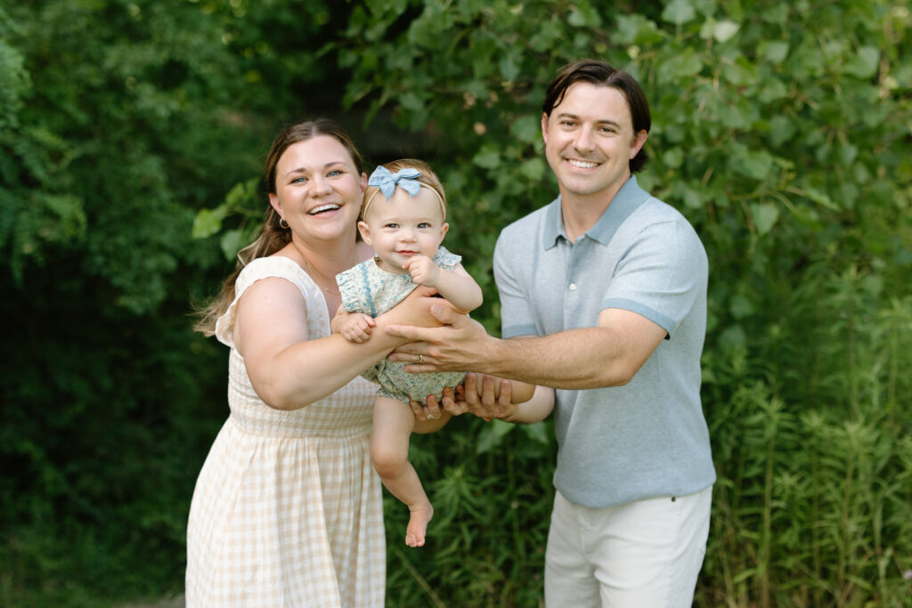 mom and dad swinging little girl during Indianapolis Milestone Photography session
