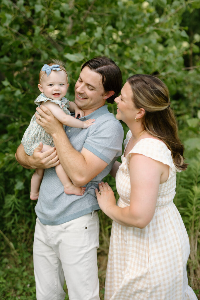 mom and dad playing with little girl during Indianapolis Milestone Photography session