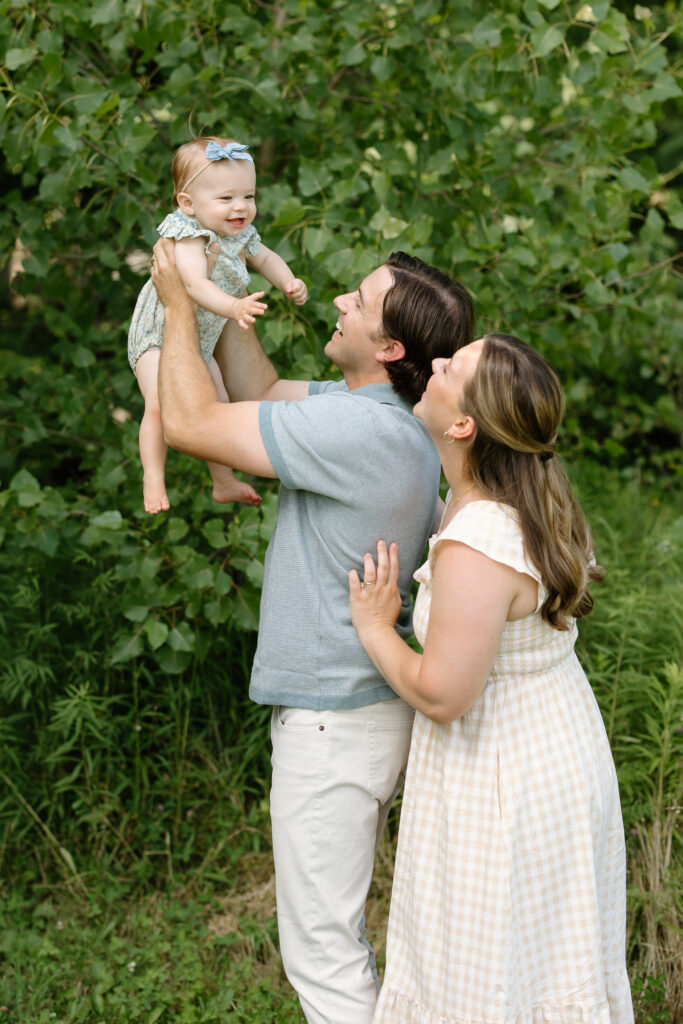 mom and dad lifting baby girl during Indianapolis Milestone Photography session