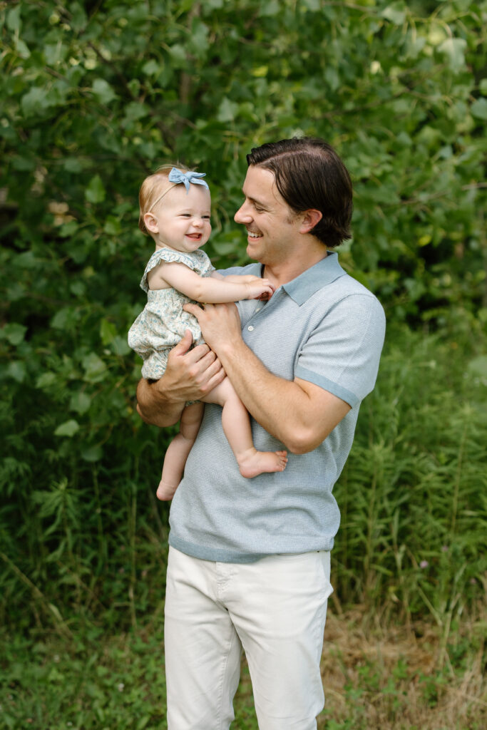 dad and baby girl smiling towards each other during Indianapolis Milestone Photography session