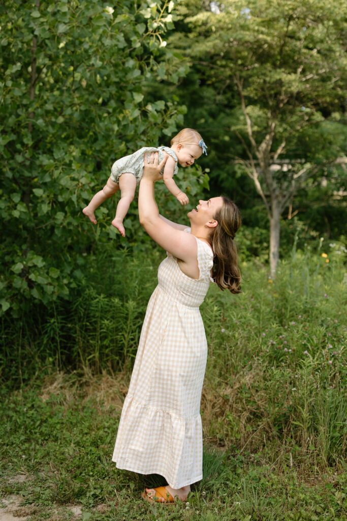 Mom throwing baby girl into air during Indianapolis Milestone Photography session