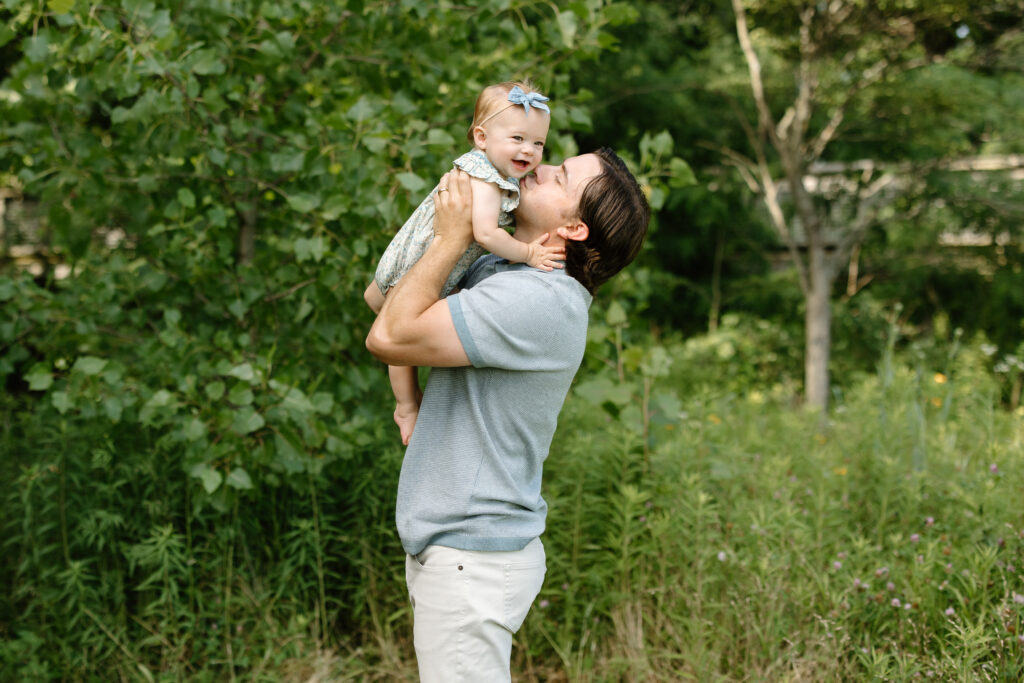 Dad kissing baby girl during Indianapolis Milestone Photography session