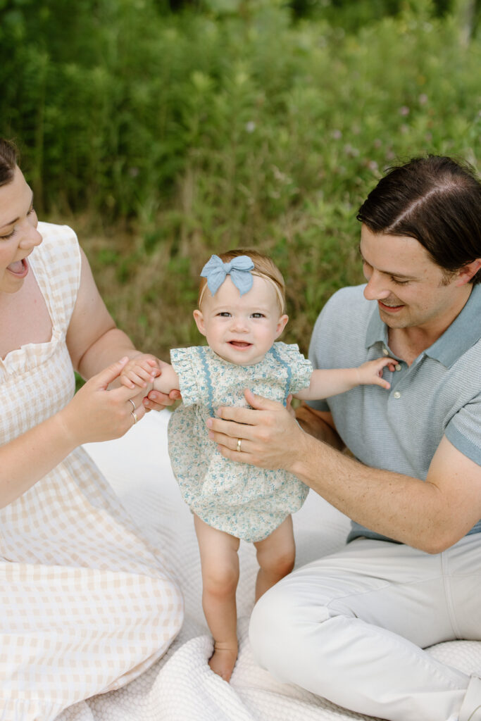 Parents holding baby in standing during Indianapolis Milestone Photography session