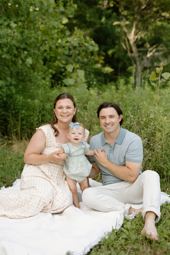 Parents and baby girl smiling towards camera during Indianapolis Milestone Photography session