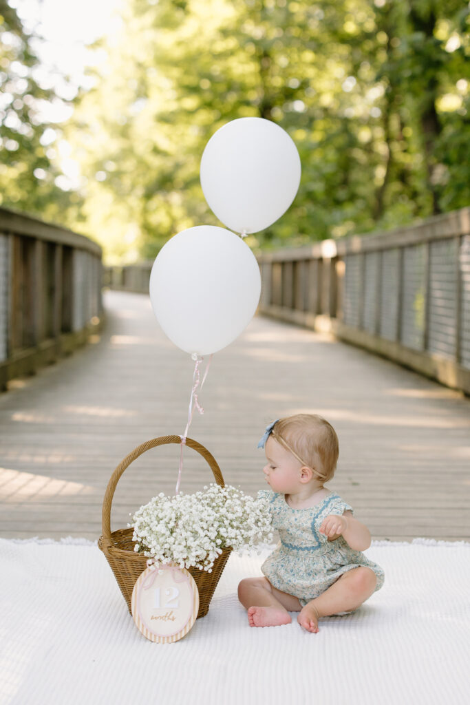Baby reaching into basket of baby's breath during Indianapolis Milestone Photography session