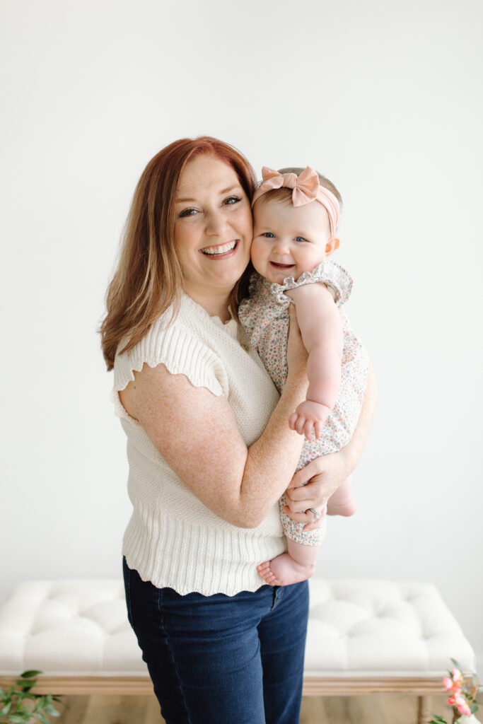 Mom and daughter smiling towards camera during Mother's Day Mini Sessions at Aspiring Eden Studio in Indianapolis