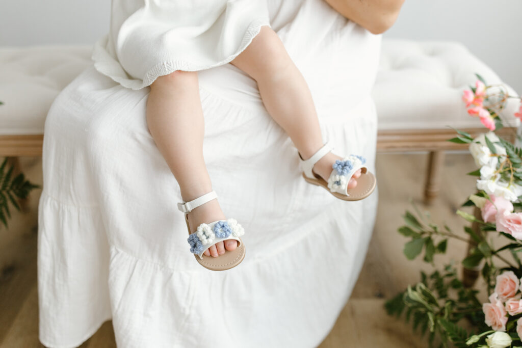 Detail photo of little girl's blue flower shoes during Mother's Day Mini Sessions at Aspiring Eden Studio in Indianapolis
