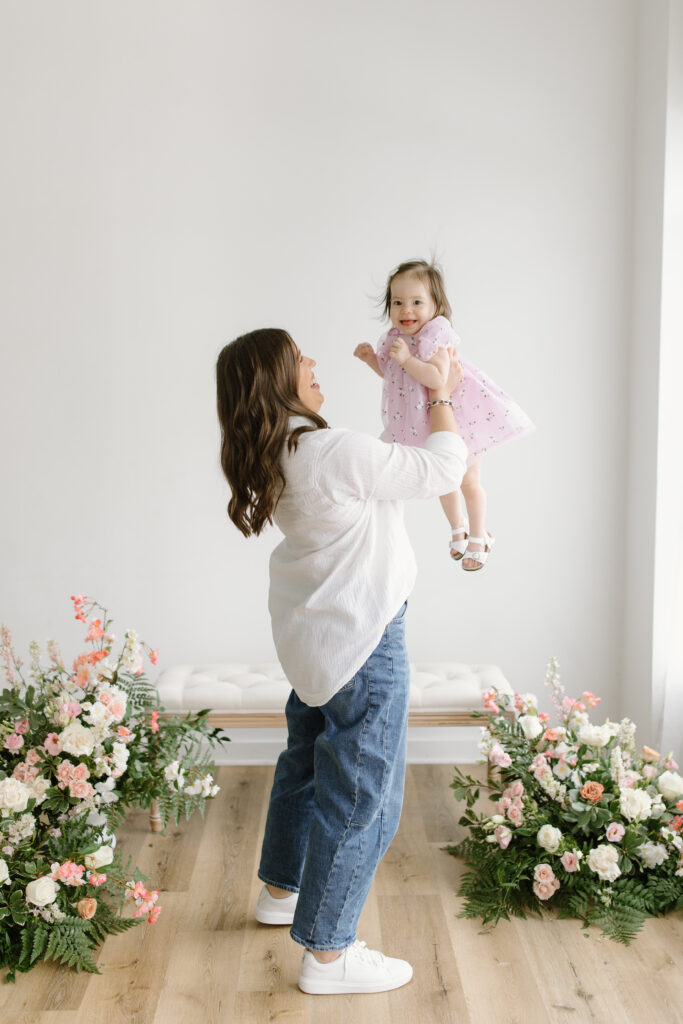 Mom lifting daughter during Mother's Day Mini Sessions at Aspiring Eden Studio in Indianapolis
