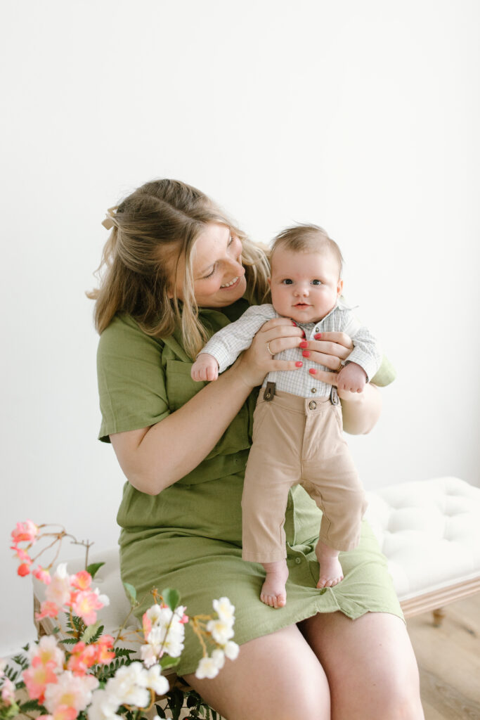 Mom holding son and son smiling towards the camera during Mother's Day Mini Sessions at Aspiring Eden Studio in Indianapolis
