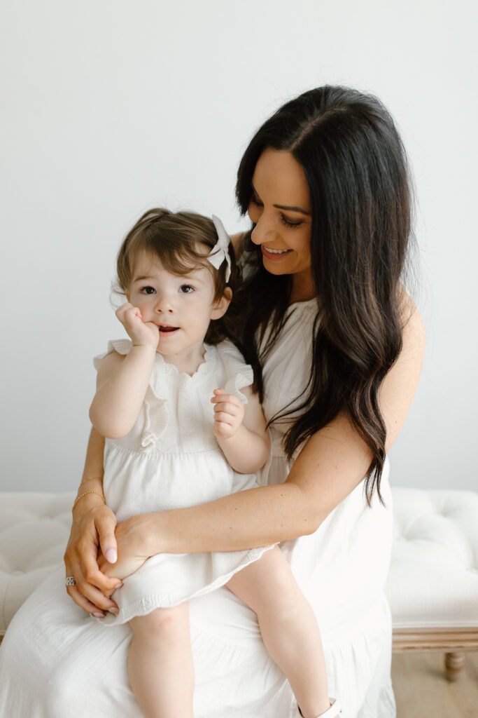 Mom holding daughter during Mother's Day Mini Sessions at Aspiring Eden Studio in Indianapolis