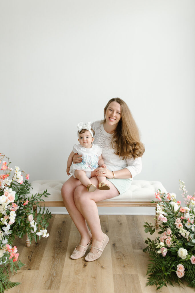 Mom sitting and holding daughter during Mother's Day Mini Sessions at Aspiring Eden Studio in Indianapolis