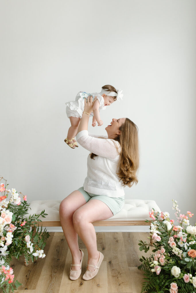 Mom lifting daughter overhead during Mother's Day Mini Sessions at Aspiring Eden Studio in Indianapolis