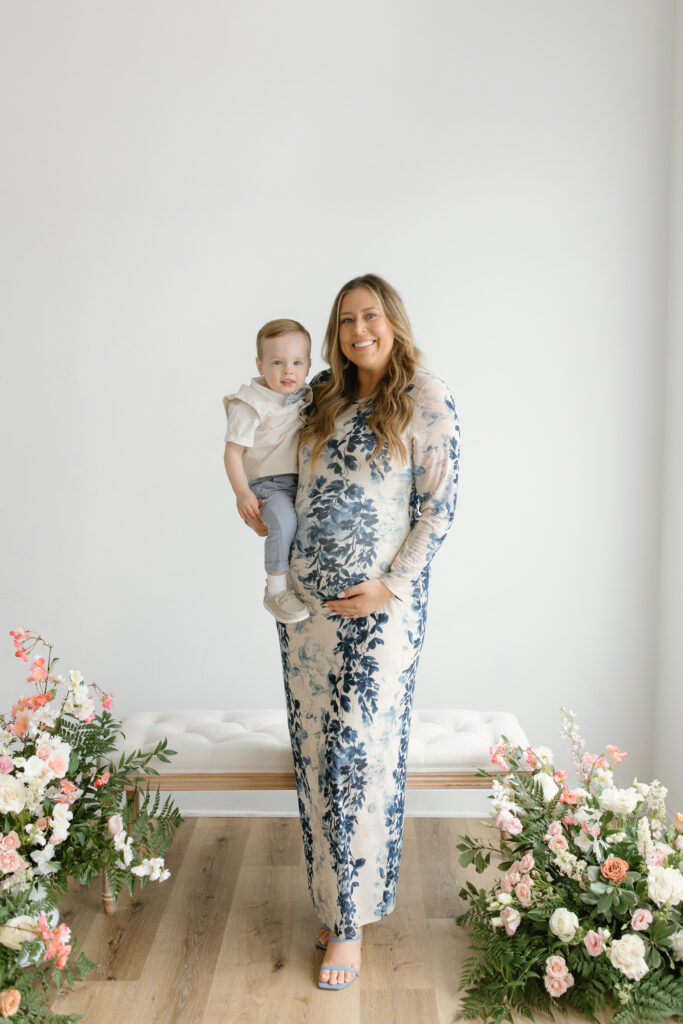 Mom holding son and baby in belly during Mother's Day Mini Session in Indianapolis