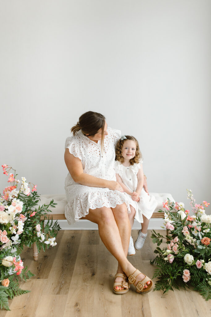 Mom hugging daughter and smiling to camera during Mother's Day Mini Sessions at Aspiring Eden Studio in Indianapolis