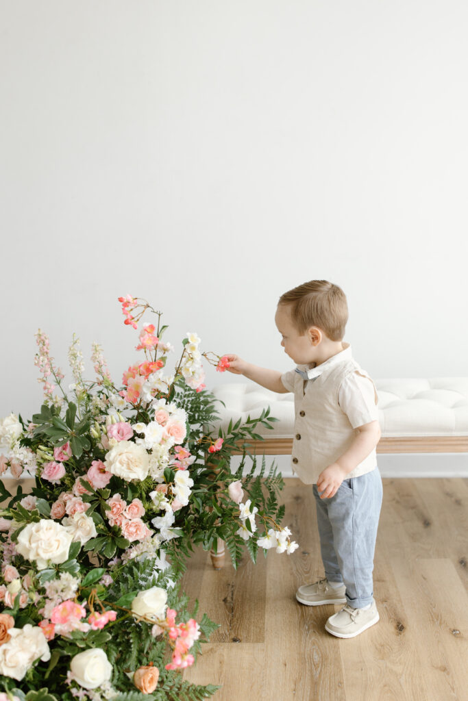 Little boy playing with flowers during Mother's Day Mini Session in Indianapolis