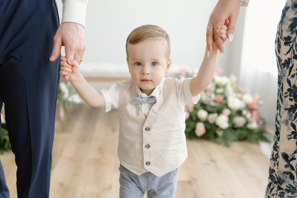 Mom and dad holding son's hands during Mother's Day Mini Session in Indianapolis