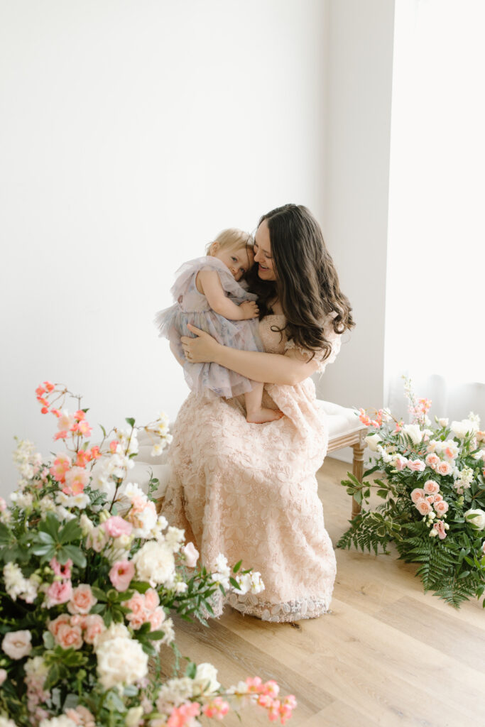 Mom snuggling her daughter during Mother's Day Mini Sessions at Aspiring Eden Studio in Indianapolis