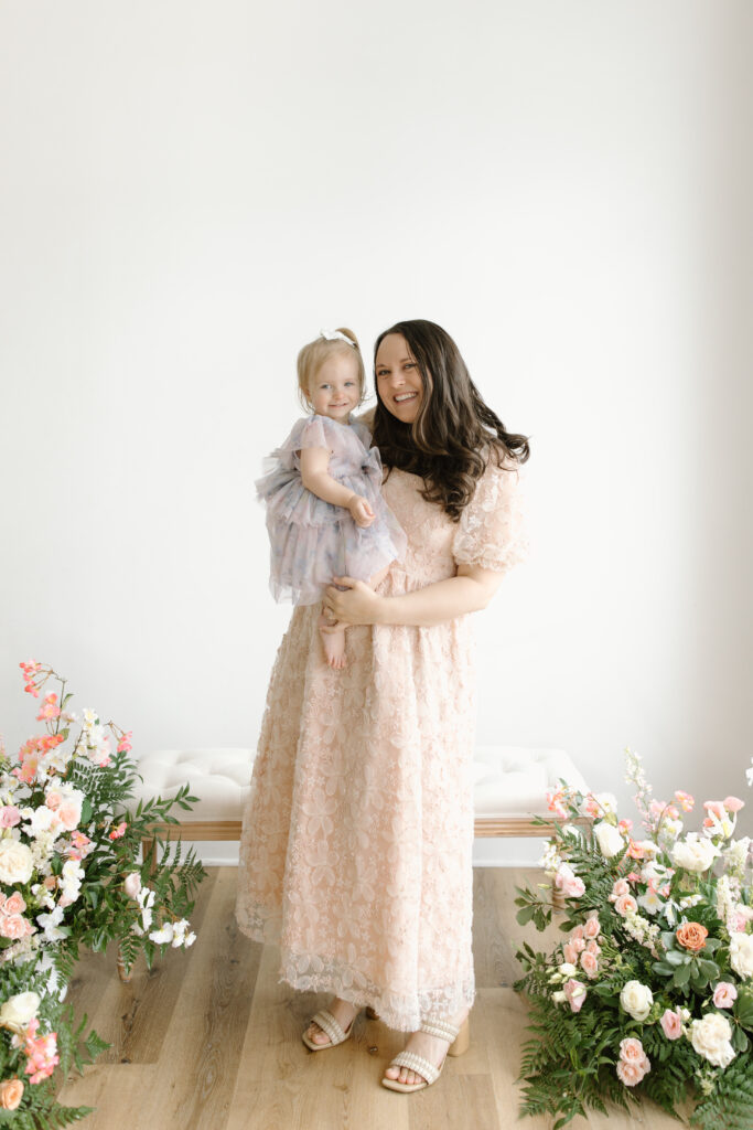 Mom holding her daughter during Mother's Day Mini Sessions at Aspiring Eden Studio in Indianapolis