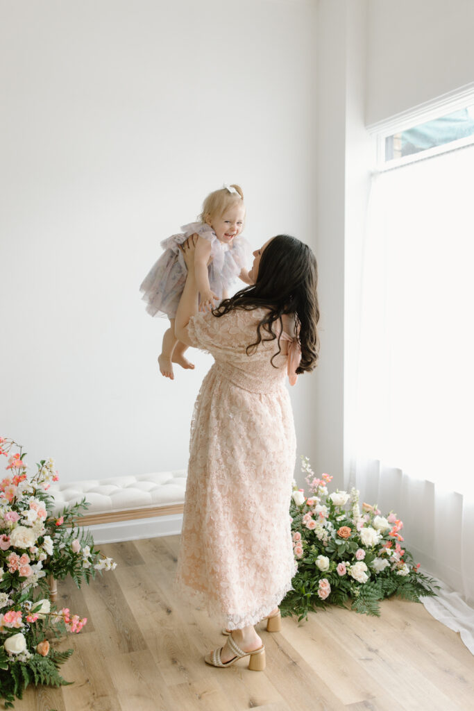 Mom lifting her daughter in the air during Mother's Day Mini Sessions at Aspiring Eden Studio in Indianapolis