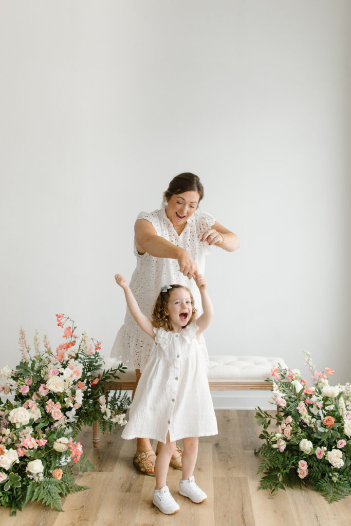 Mom and daughter dancing during Mother's Day Mini Sessions at Aspiring Eden Studio in Indianapolis