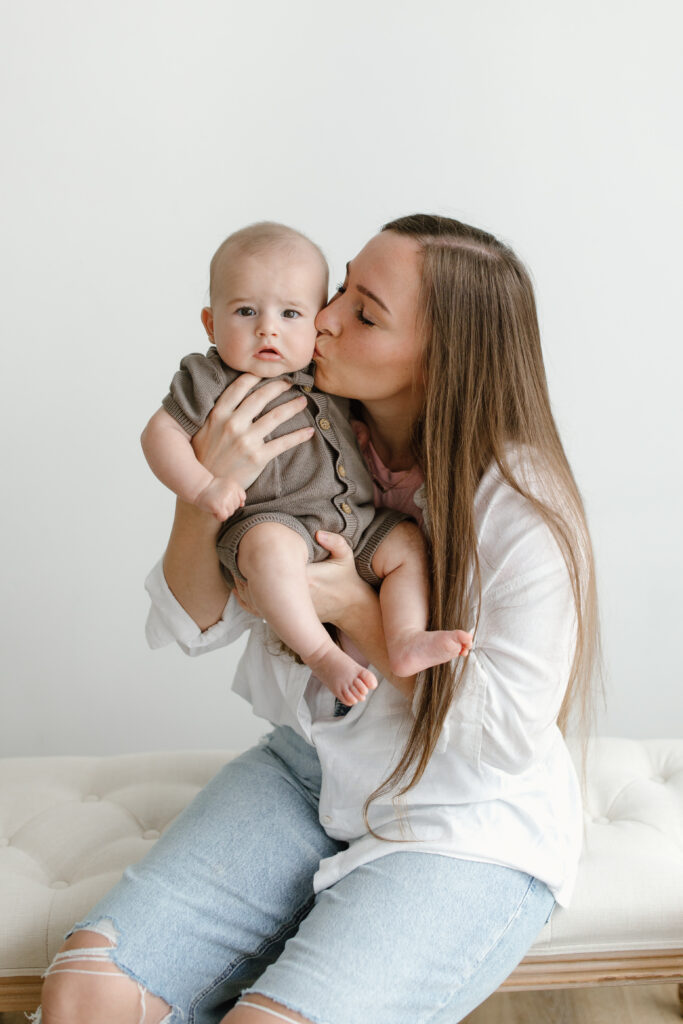 Mom kissing son during Mother's Day Mini Sessions at Aspiring Eden Studio in Indianapolis