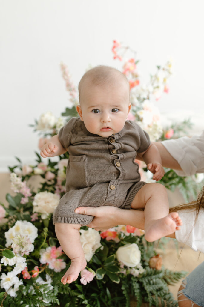 Little boy held in front of camera during Mother's Day Mini Sessions at Aspiring Eden Studio in Indianapolis