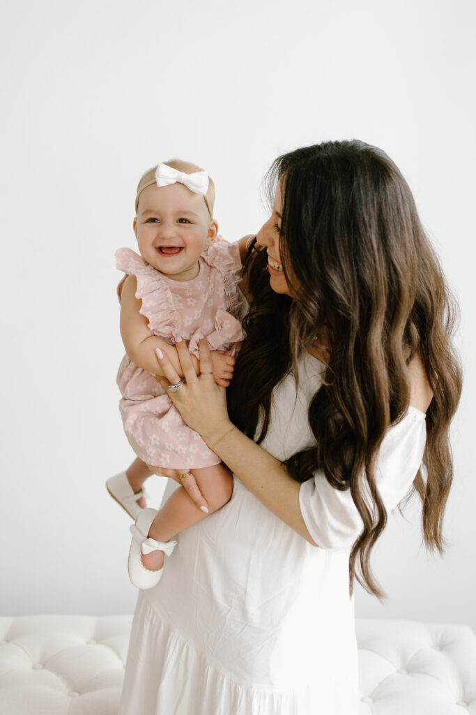 Mom laughing towards her daughter during Mother's Day Mini Sessions at Aspiring Eden Studio in Indianapolis