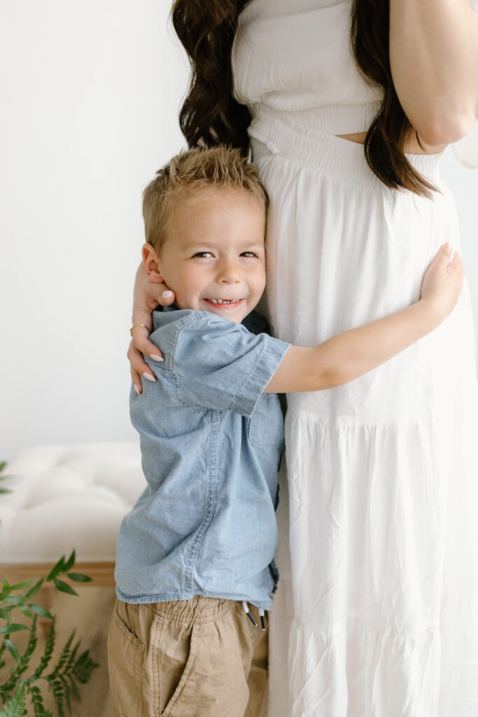 Son hugging his mom during Mother's Day Mini Sessions at Aspiring Eden Studio in Indianapolis