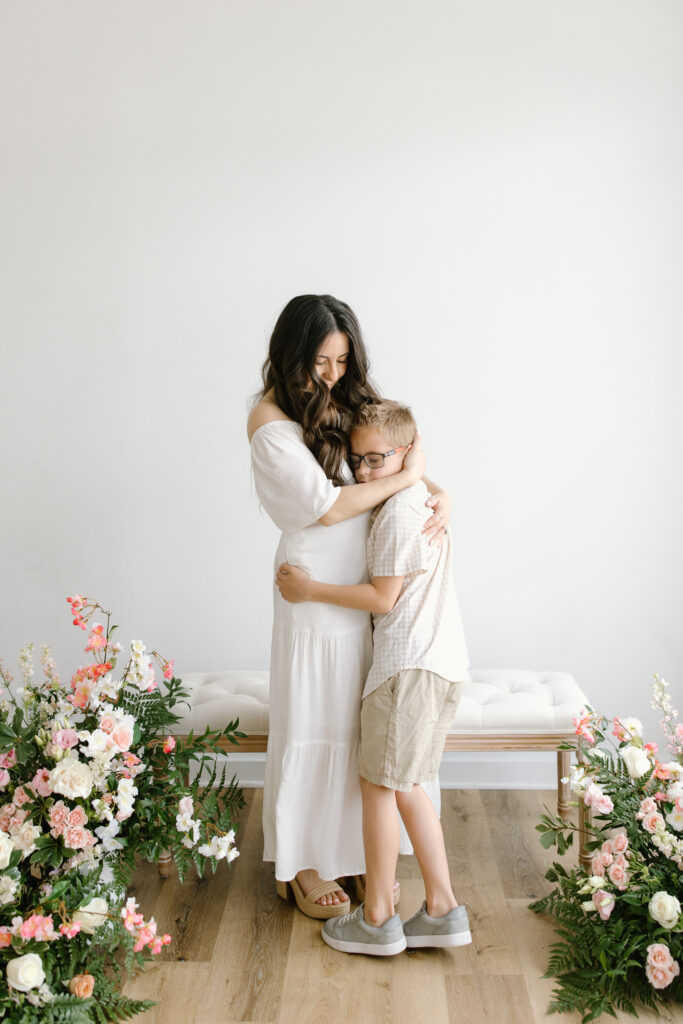 mom hugging her son tightly during Mother's Day Mini Sessions at Aspiring Eden Studio in Indianapolis