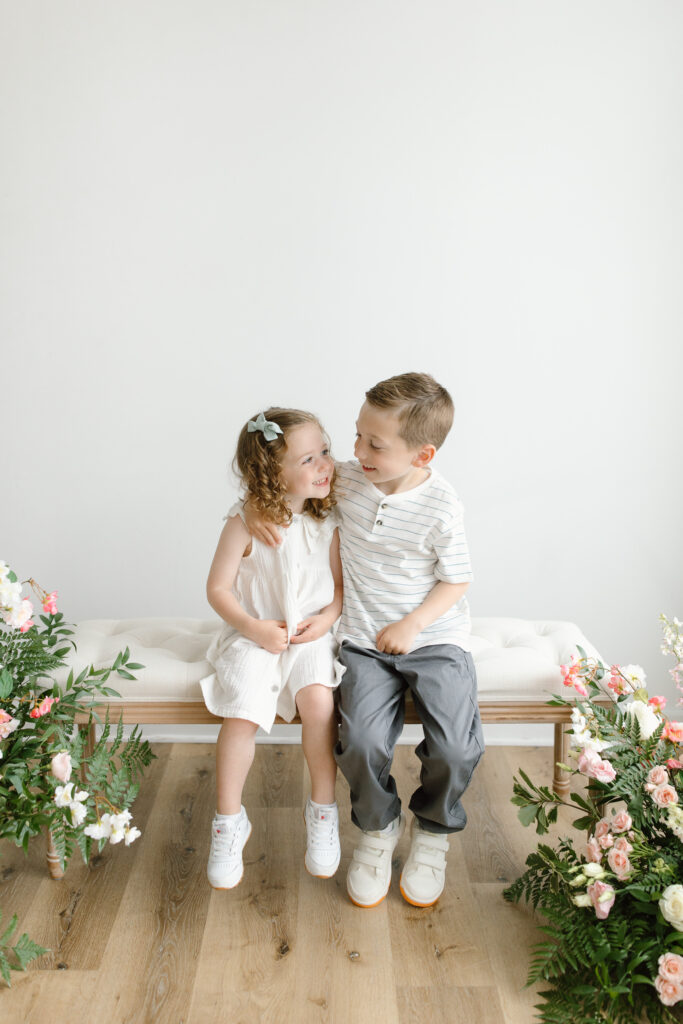 Kids hugging and smiling to eachother during Mother's Day Mini Sessions at Aspiring Eden Studio in Indianapolis