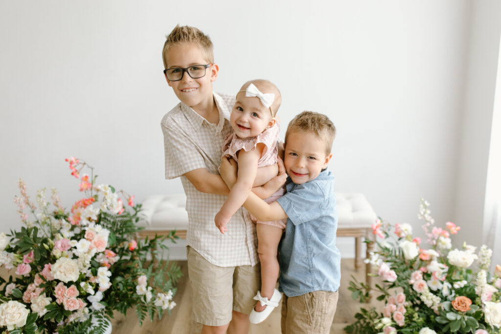 Brothers holding up their sister during Mother's Day Mini Sessions at Aspiring Eden Studio in Indianapolis