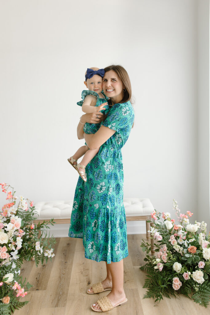 Mom and daughter smiling towards camera during Mother's Day Mini Sessions at Aspiring Eden Studio in Indianapolis