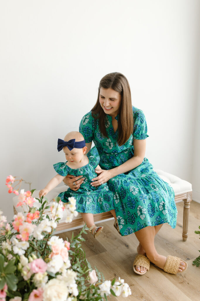 Mom and daughter playing with flowers during Mother's Day Mini Sessions at Aspiring Eden Studio in Indianapolis