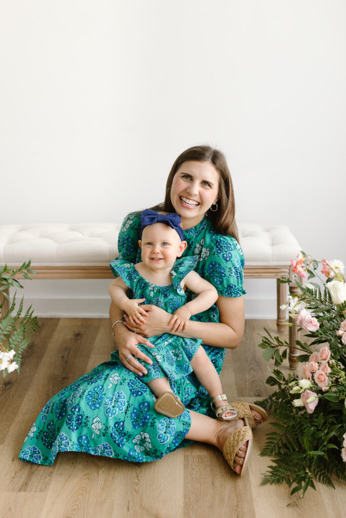 Daughter sitting on mom's lap during Mother's Day Mini Sessions at Aspiring Eden Studio in Indianapolis