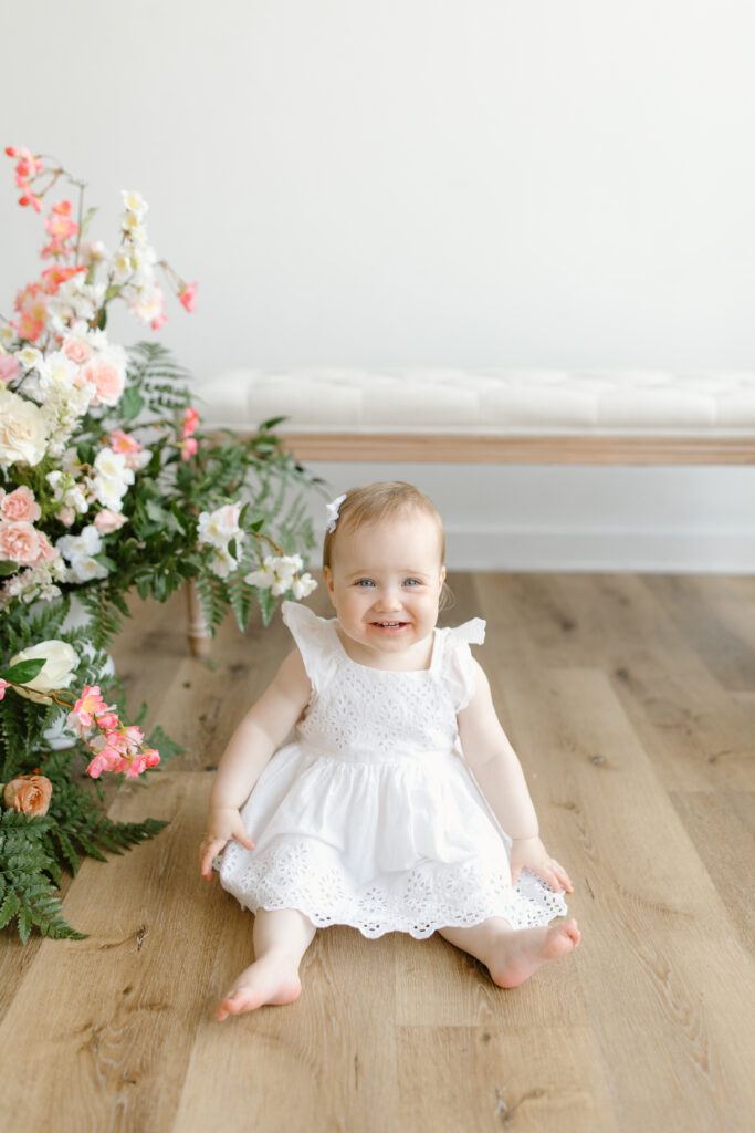Little girl sitting and smiling during Mother's Day Mini Sessions at Aspiring Eden Studio in Indianapolis