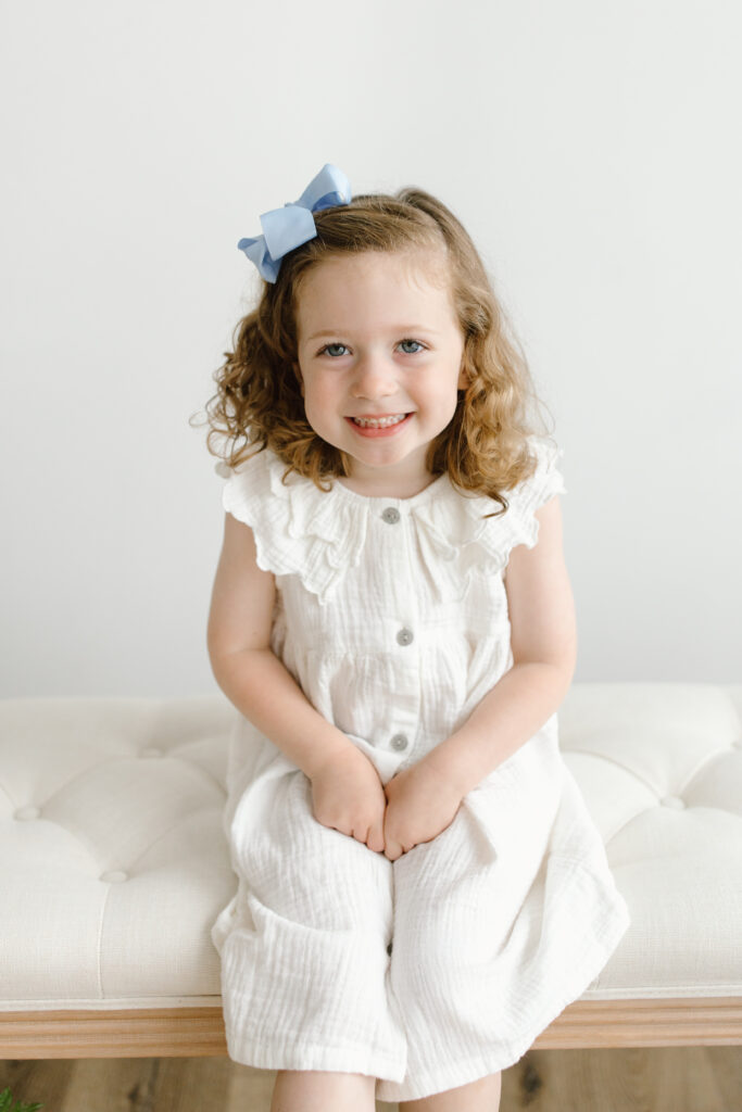 Little girl smiling towards the camera during Mother's Day Mini Sessions at Aspiring Eden Studio in Indianapolis