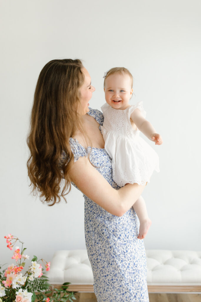 Mom and daughter laughing to camera during Mother's Day Mini Sessions at Aspiring Eden Studio in Indianapolis