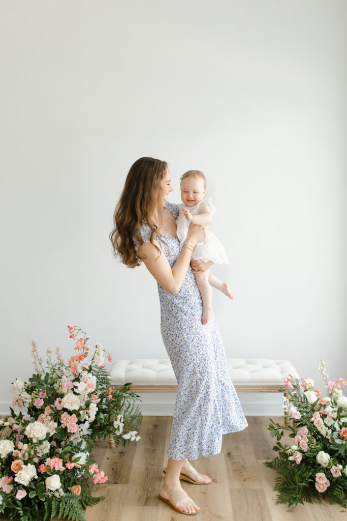 Mom holding daughter and dancing during Mother's Day Mini Sessions at Aspiring Eden Studio in Indianapolis