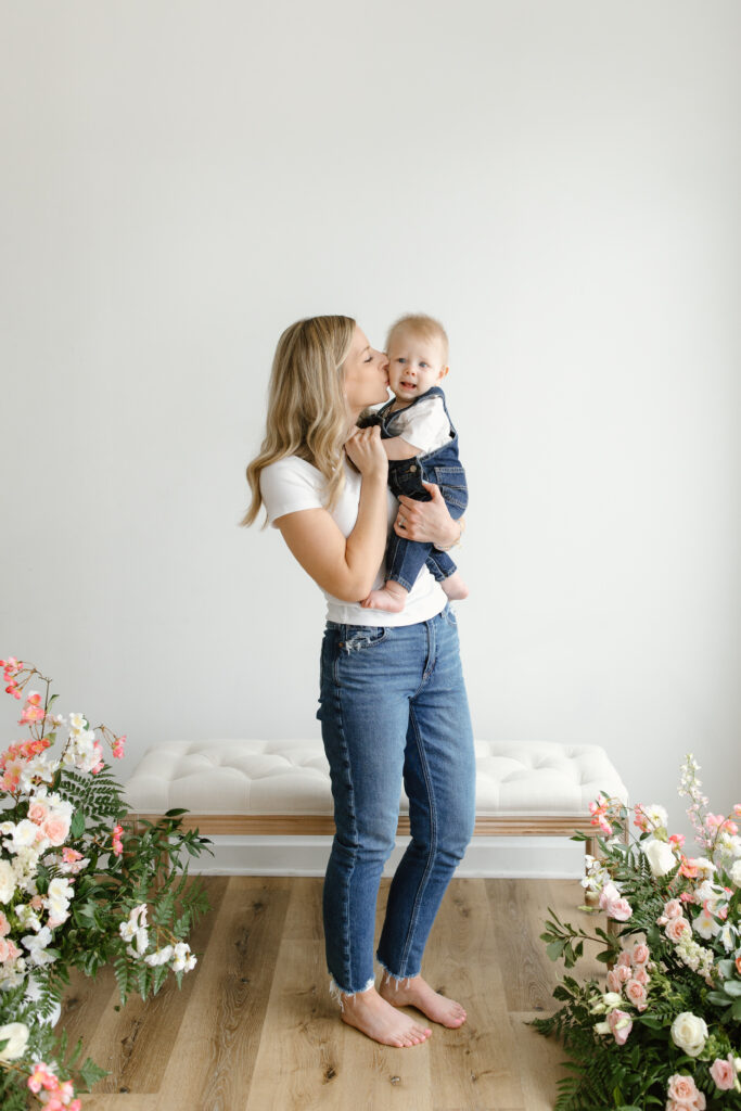 Mom kissing son on the cheek during Mother's Day Mini Sessions at Aspiring Eden Studio in Indianapolis