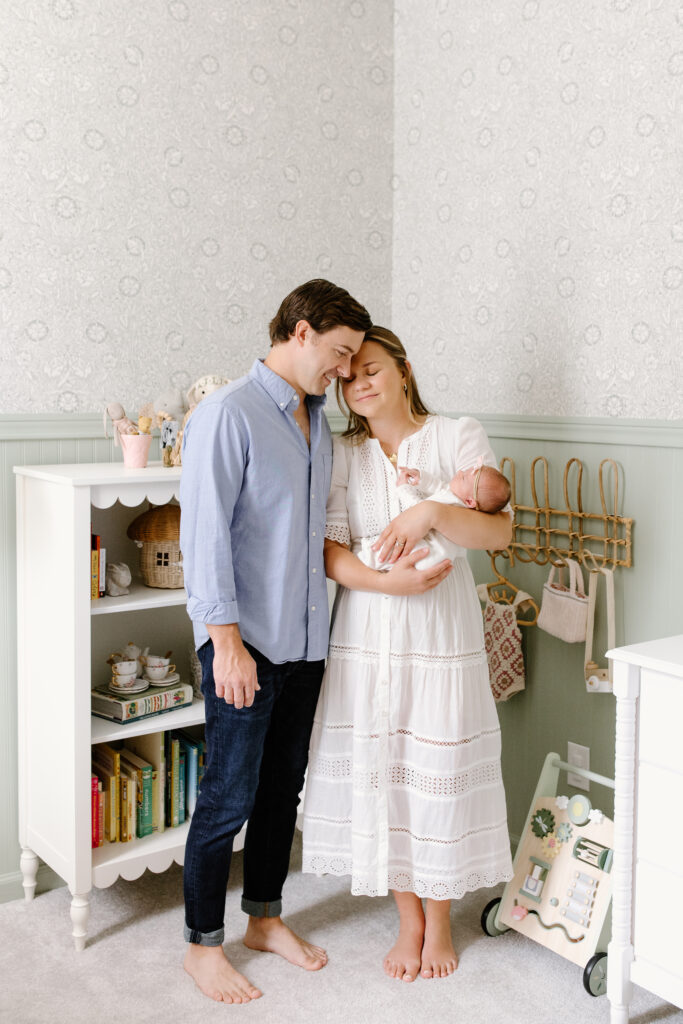 parents snuggling into each other during newborn photos in Fishers, IN