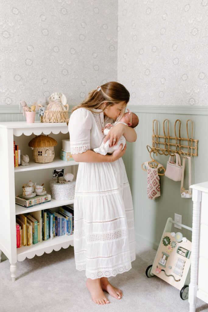 mom kissing newborn during newborn photos in Fishers, IN