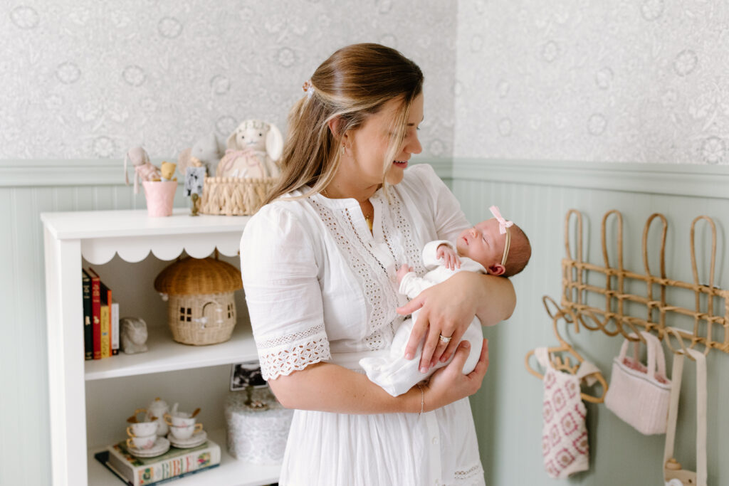mom holding newborn during newborn photos in Fishers, IN