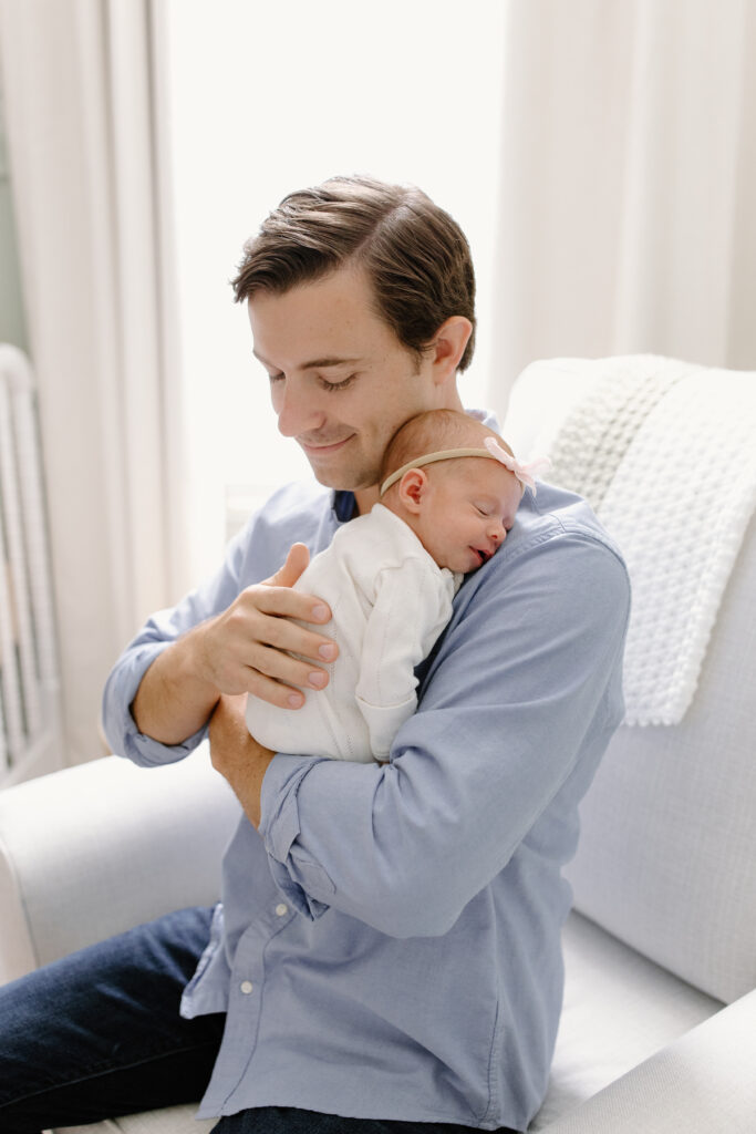 dad burping baby during newborn photos in Fishers, IN