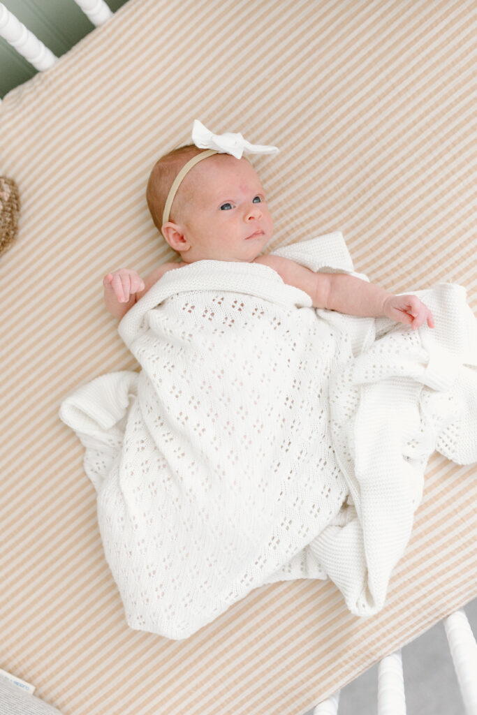 little girl swaddled in blanket during newborn photos in Fishers, IN