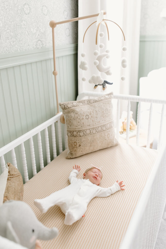 baby lying in crib during newborn photos in Fishers, IN
