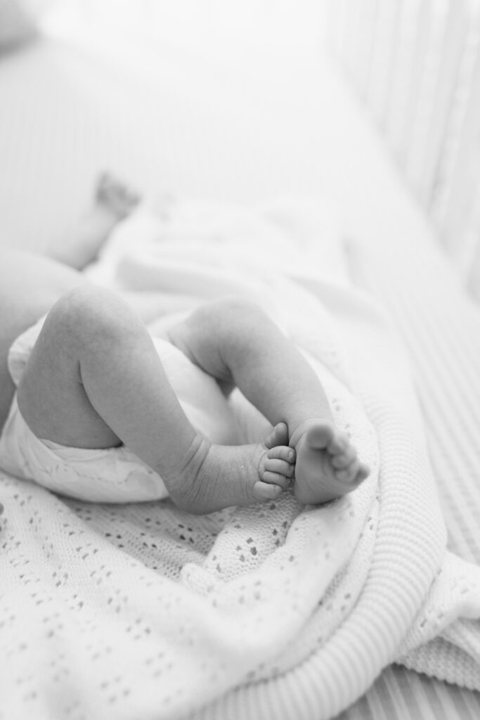 black and white detail photo of feet during newborn photos in Fishers, IN