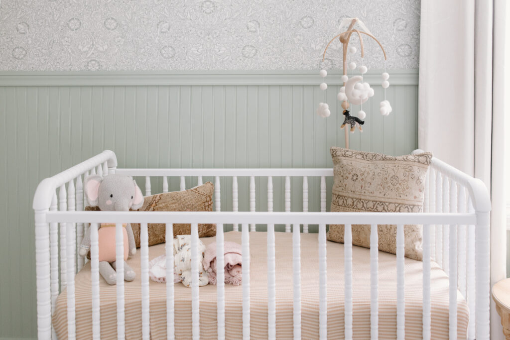 detail photo of crib with pastel colors during newborn photos in Fishers, IN