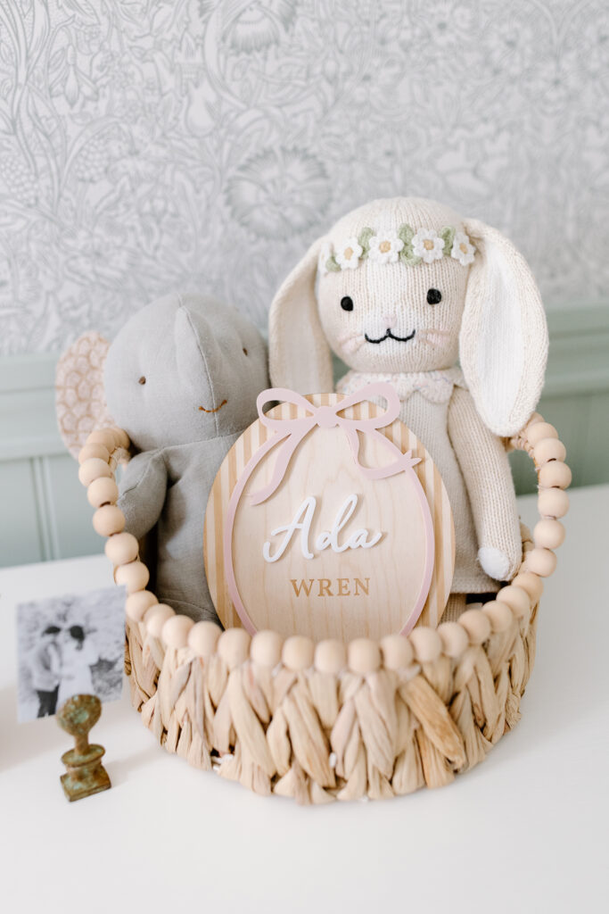detail photo of basket with wooden name block during newborn photos in Fishers, IN