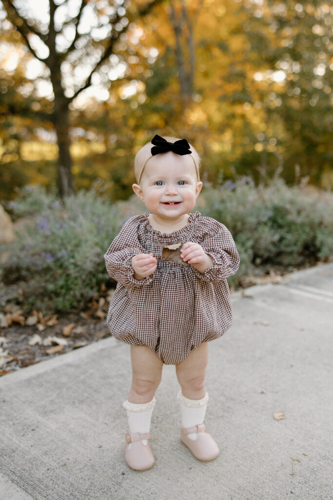 Baby smiling towards camera during fall mini session in Carmel, IN with capturing simplicity photography